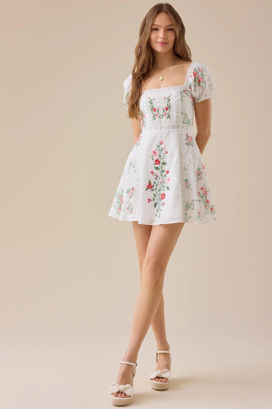 Girl wearing a white floral mini dress