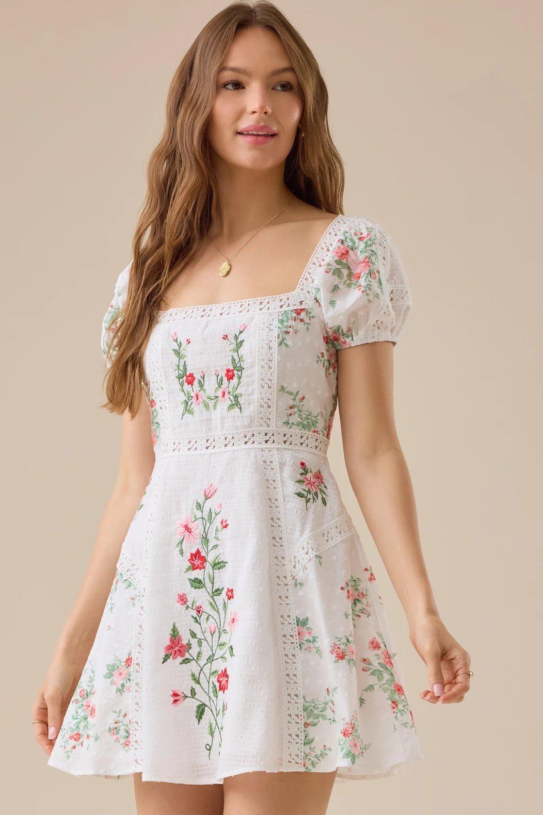 girl wearing a white floral mini dress