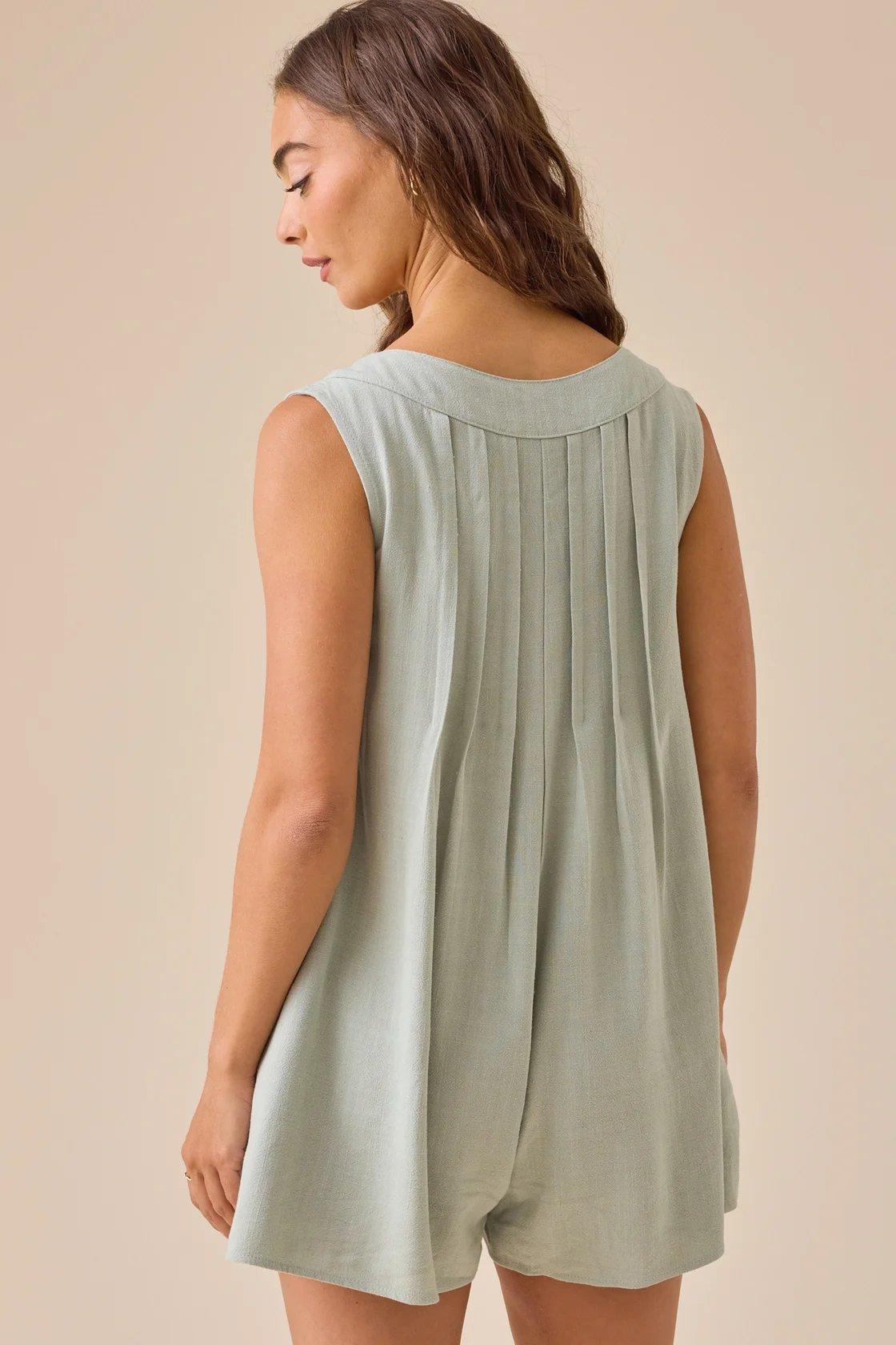 girl wearing a sage green romper