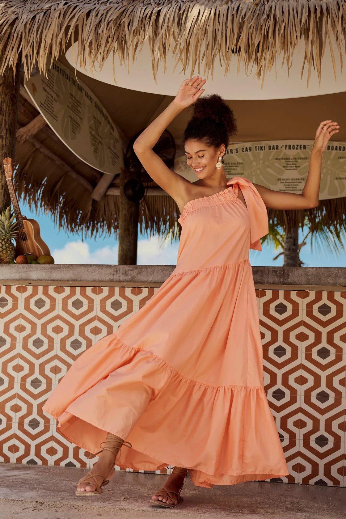 girl wearing a peach colored tiered maxi dress