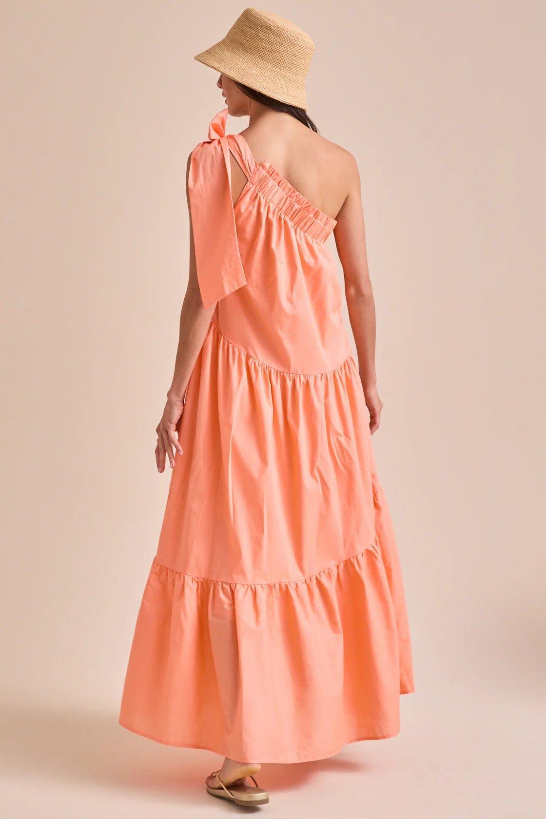girl wearing a coral flowy maxi dress