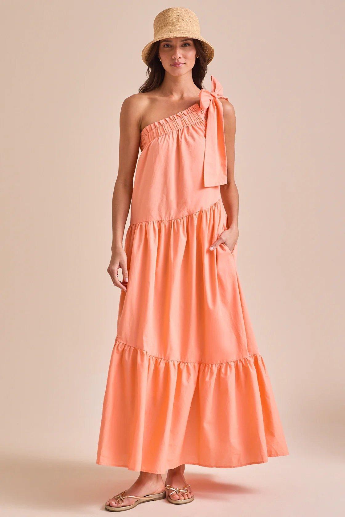 Girl wearing a coral flowy maxi dress