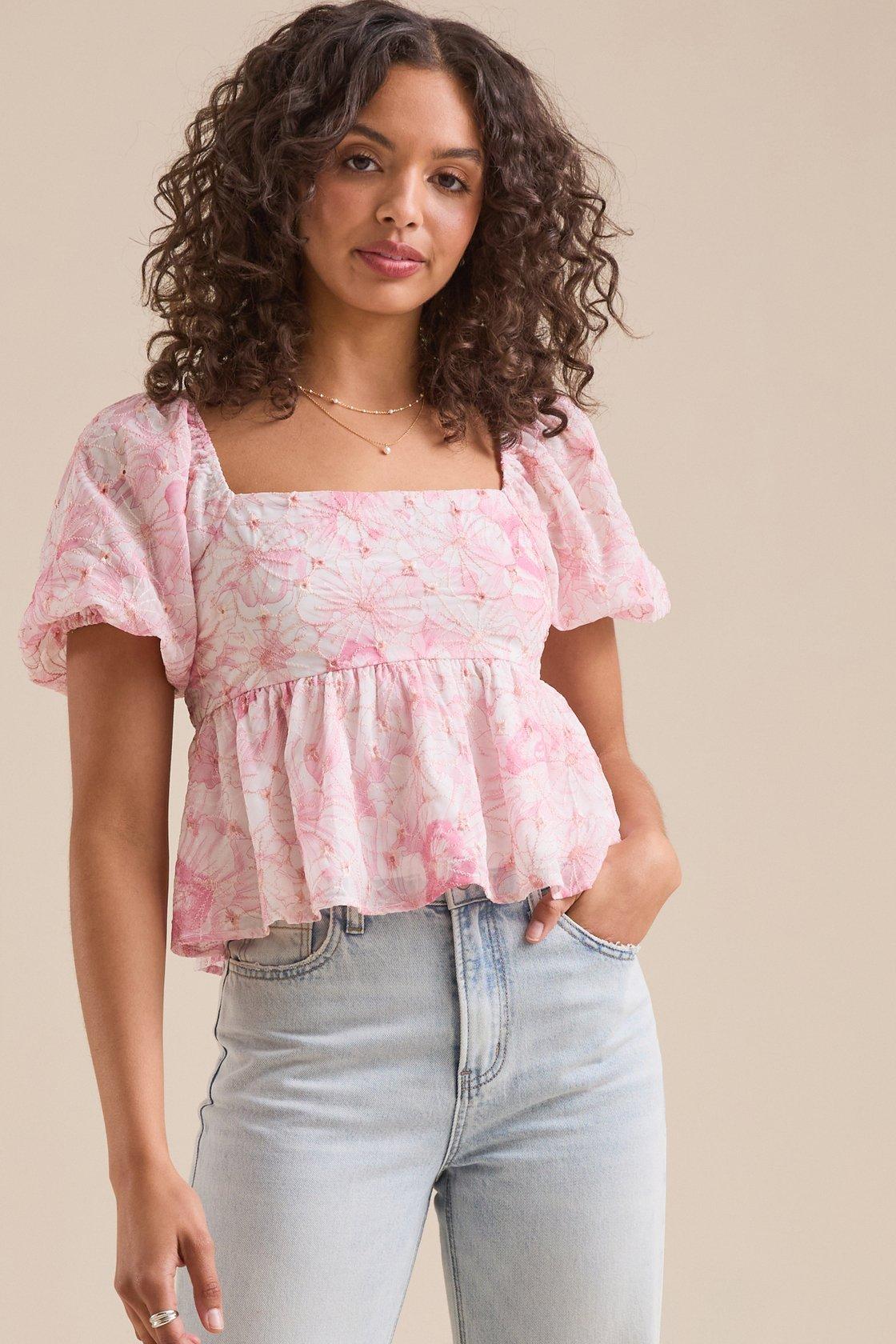 girl wearing a white and pink babydoll top