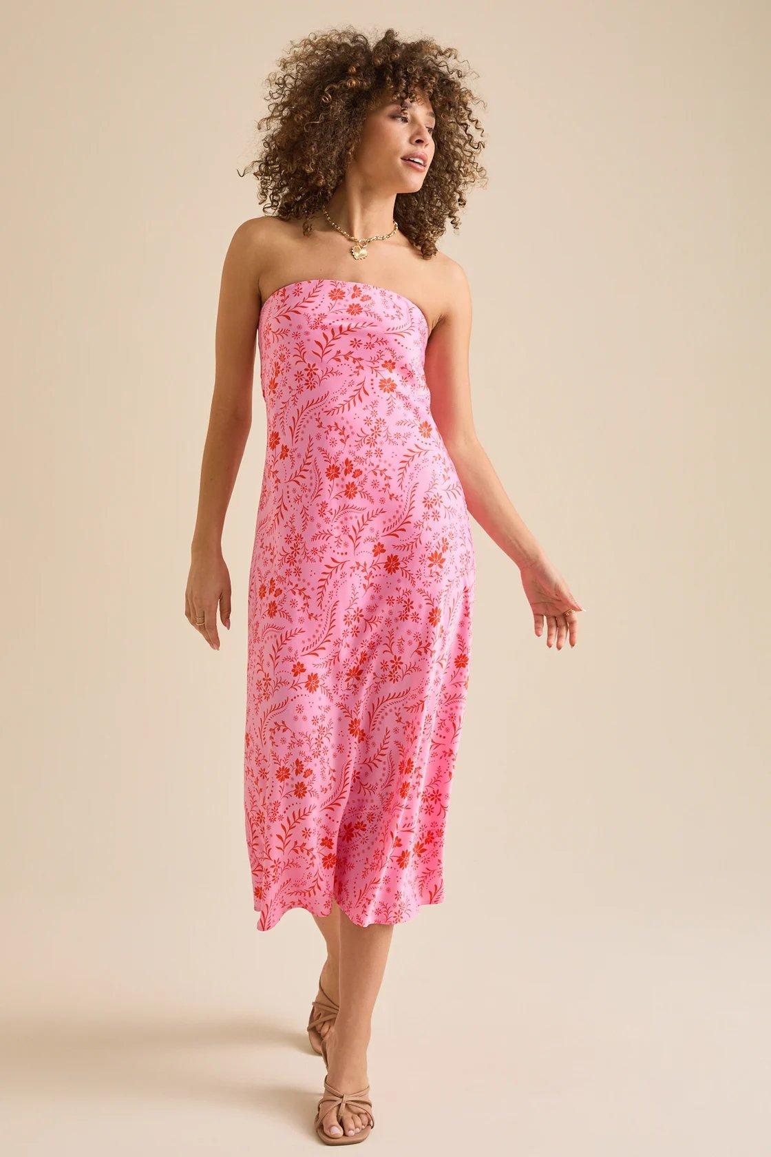 Girl wearing a strapless pink and red floral dress