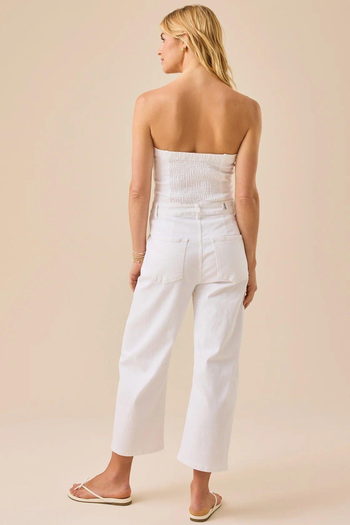 girl wearing a white strapless jumpsuit