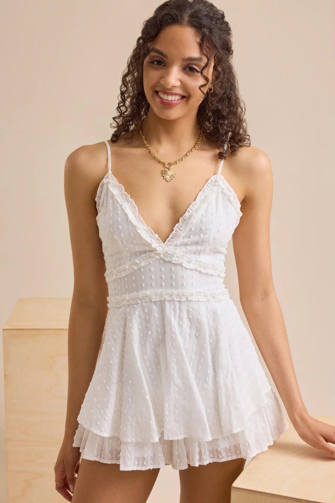 girl wearing a white layered ruffle romper