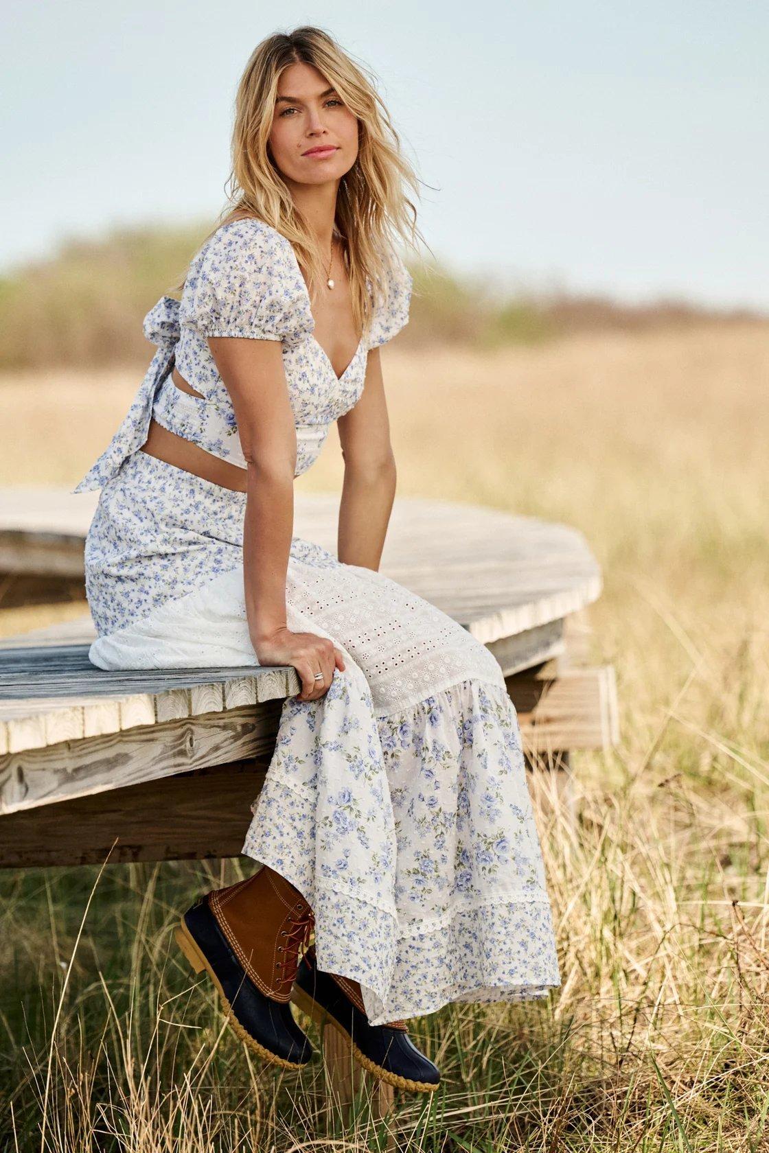 Girl wearing a blue and ivory floral maxi skirt