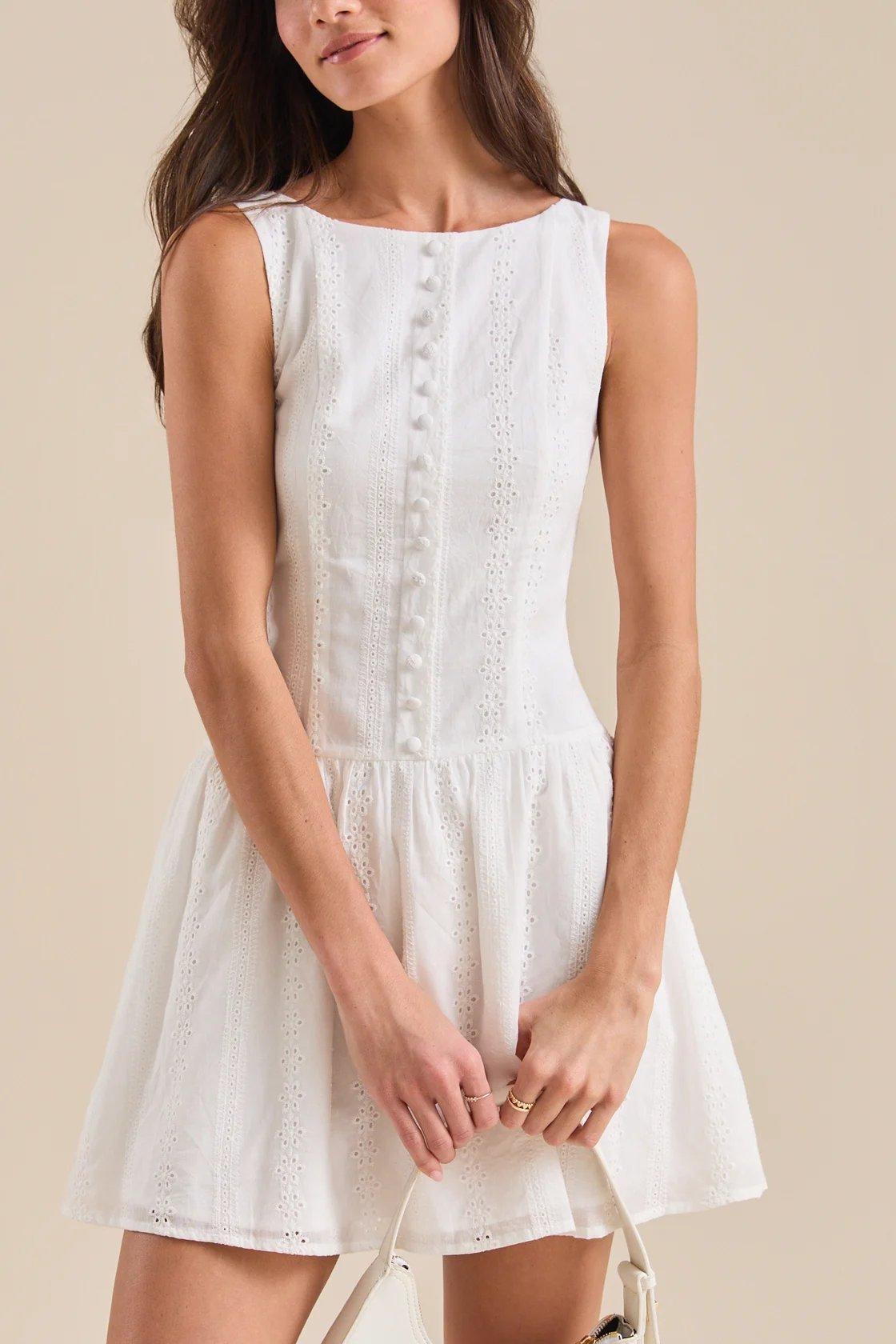 girl wearing a white eyelet mini dress