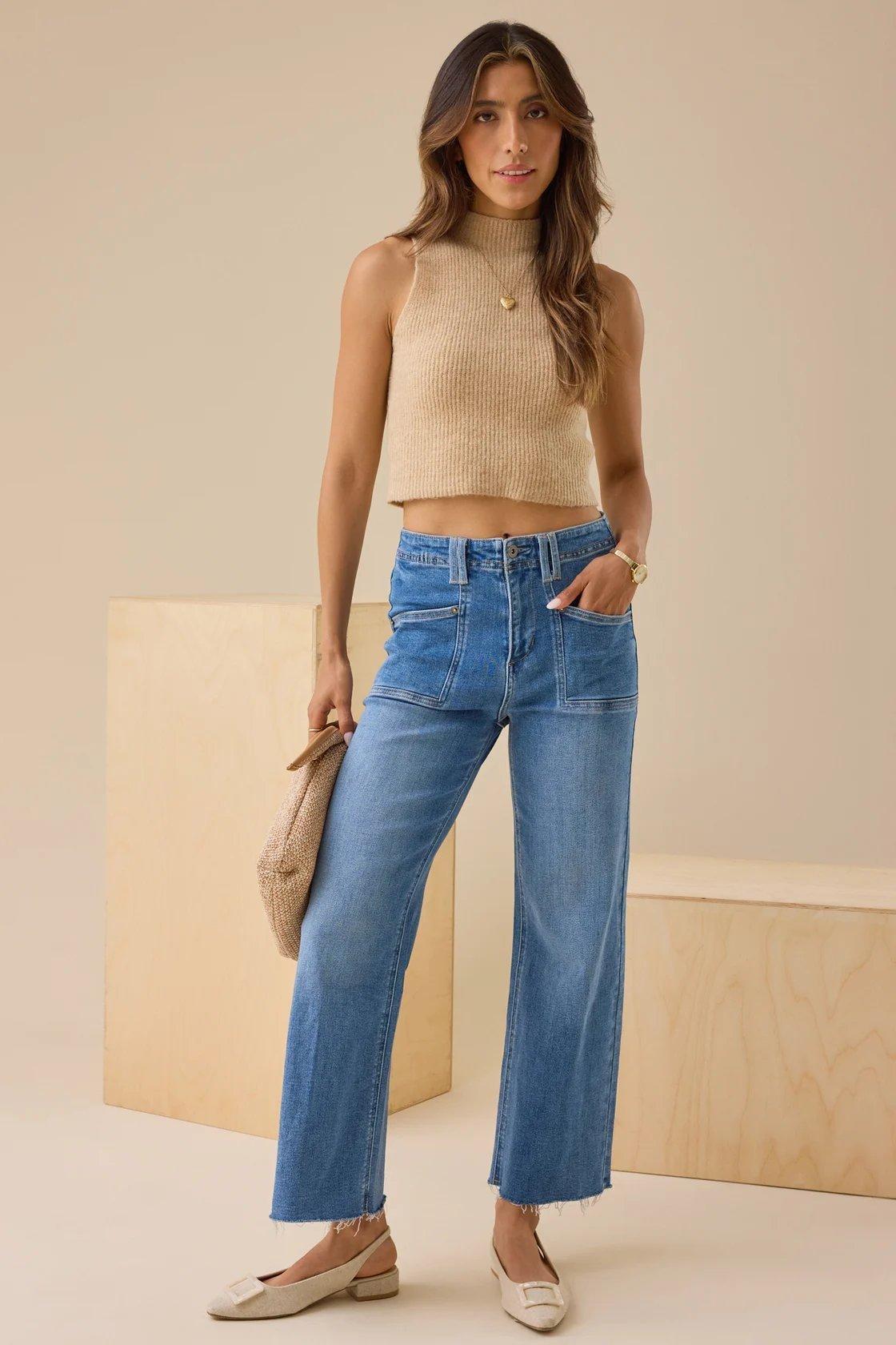 Girl wearing a beige top and cropped blue jeans
