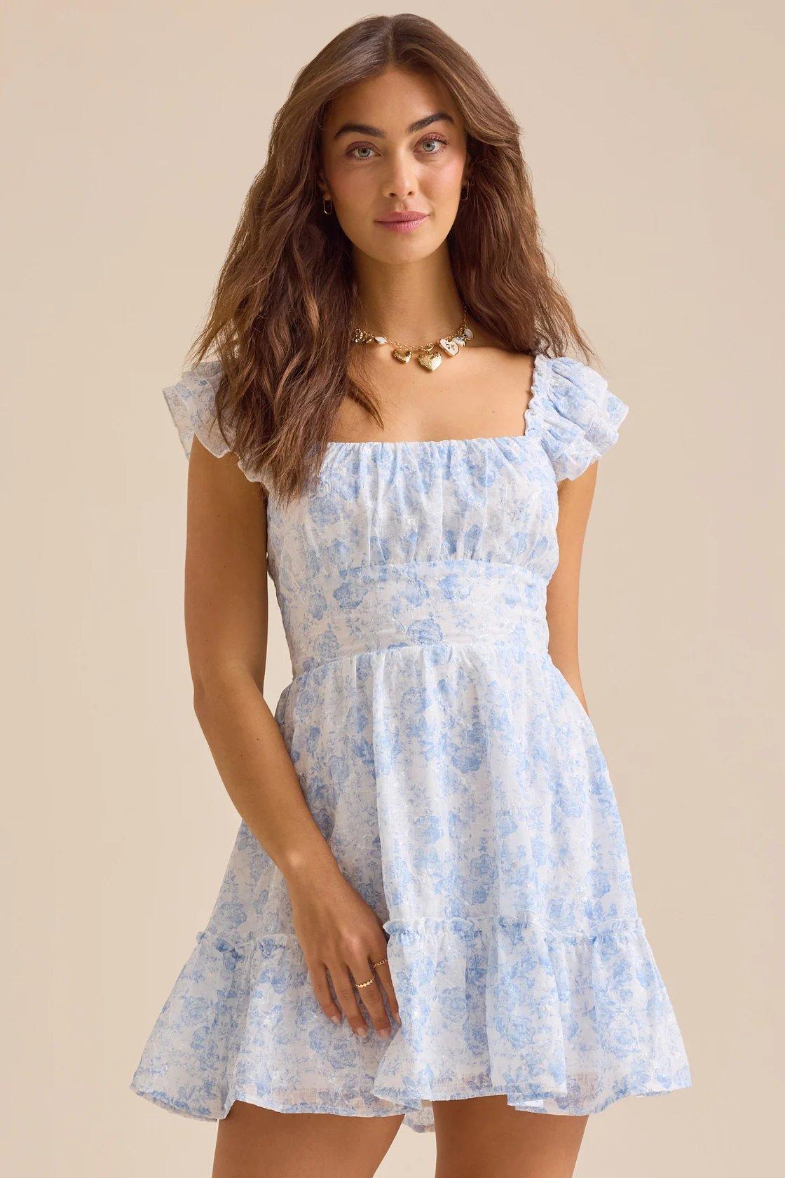 Girl wearing a light blue floral mini dress