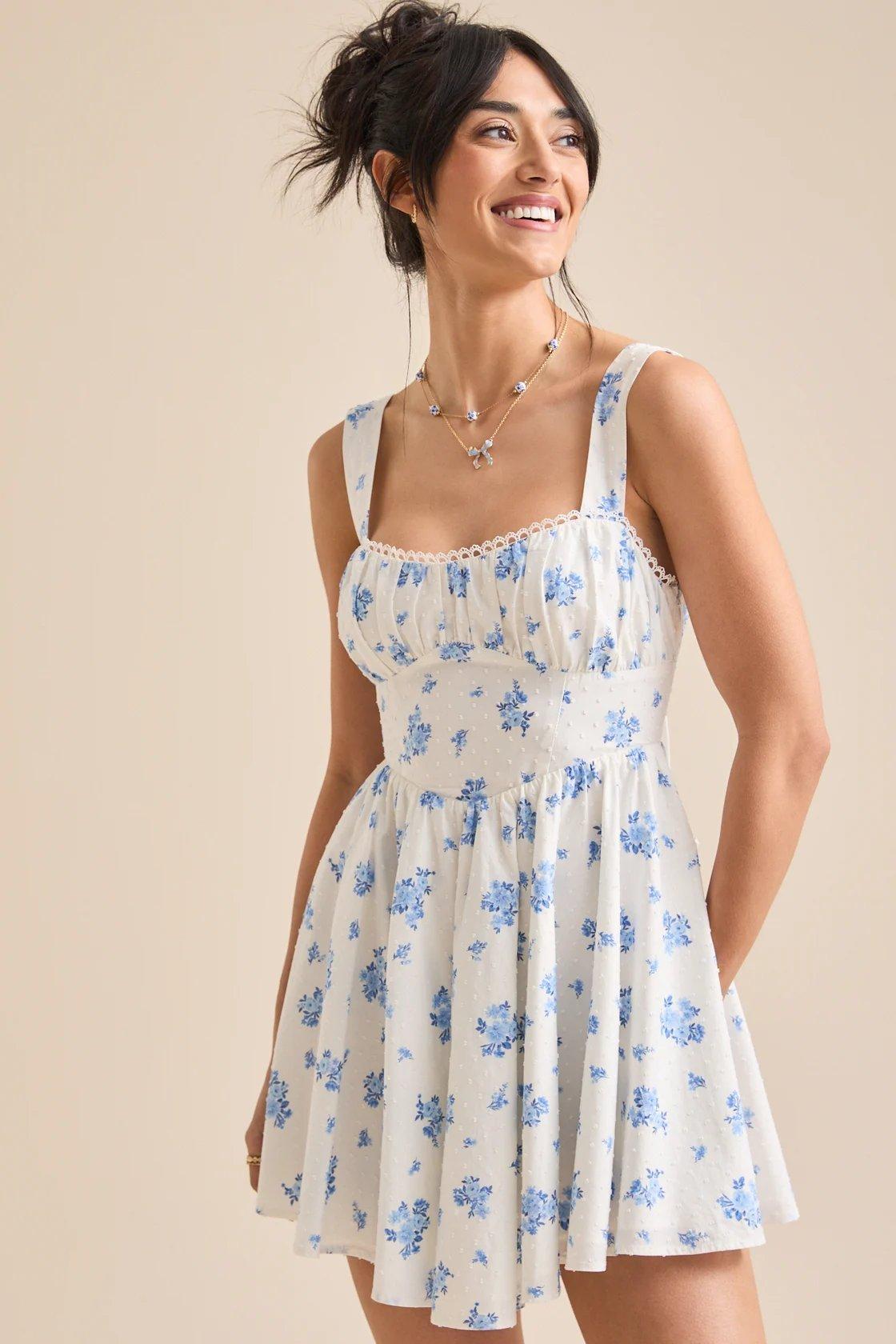 Girl wearing a white mini dress with blue florals