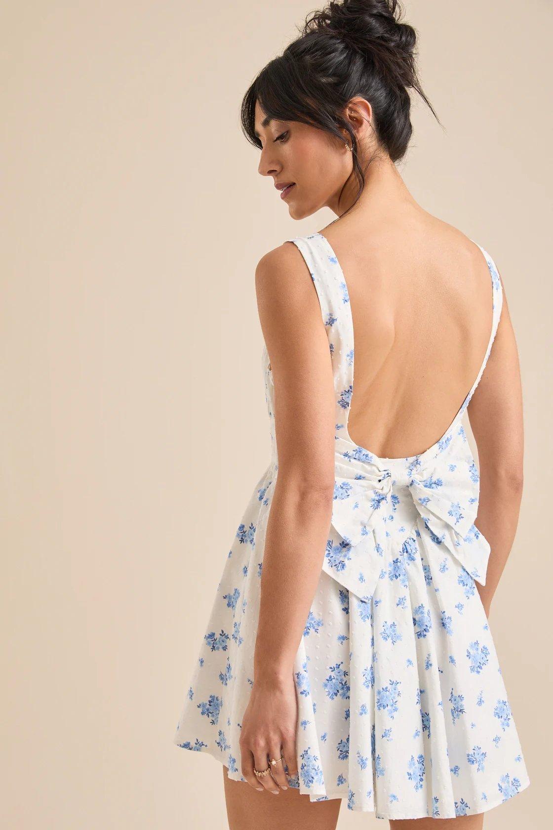 girl wearing a white mini dress with blue forals