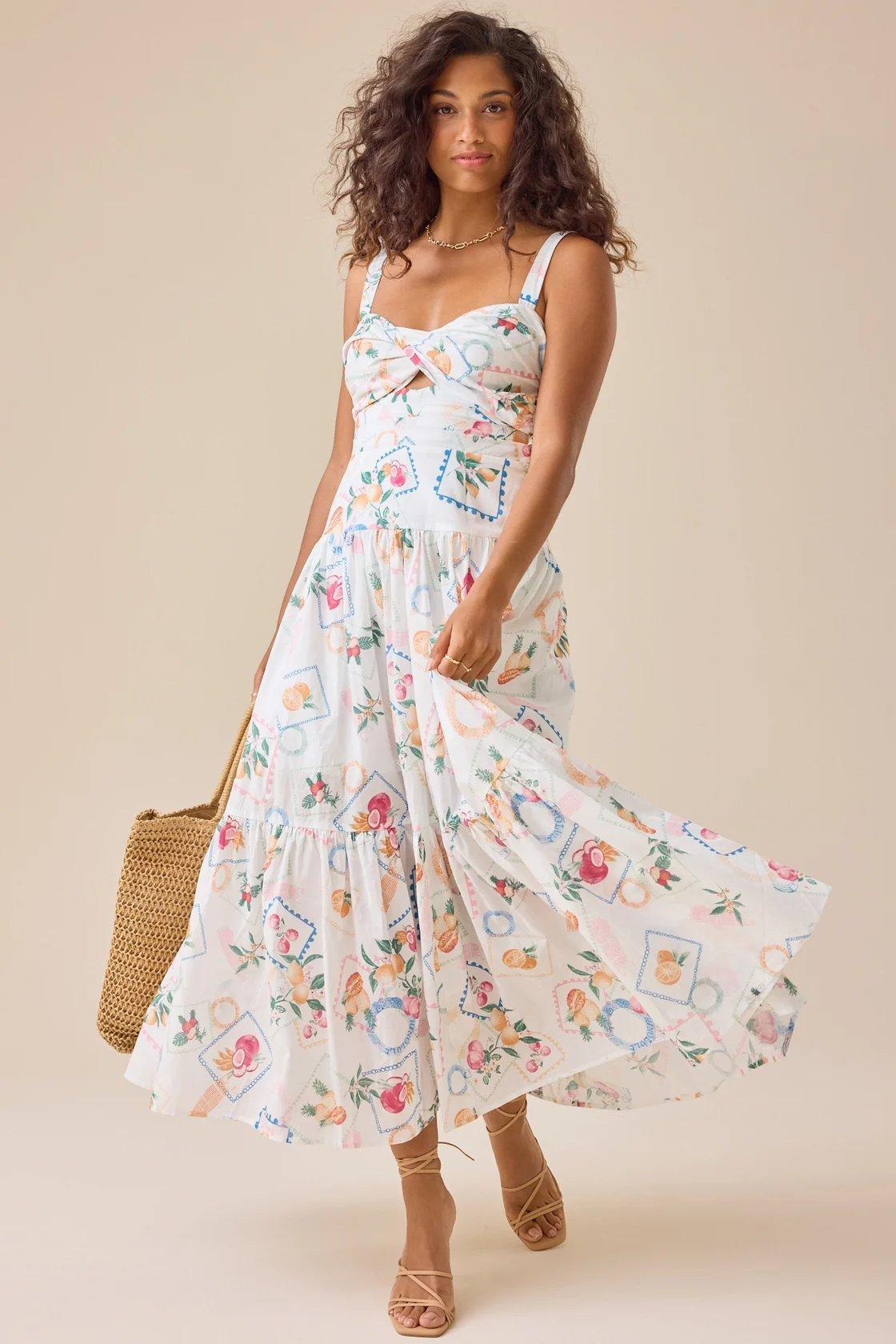 girl wearing a white maxi dress with multi-colored summer prints