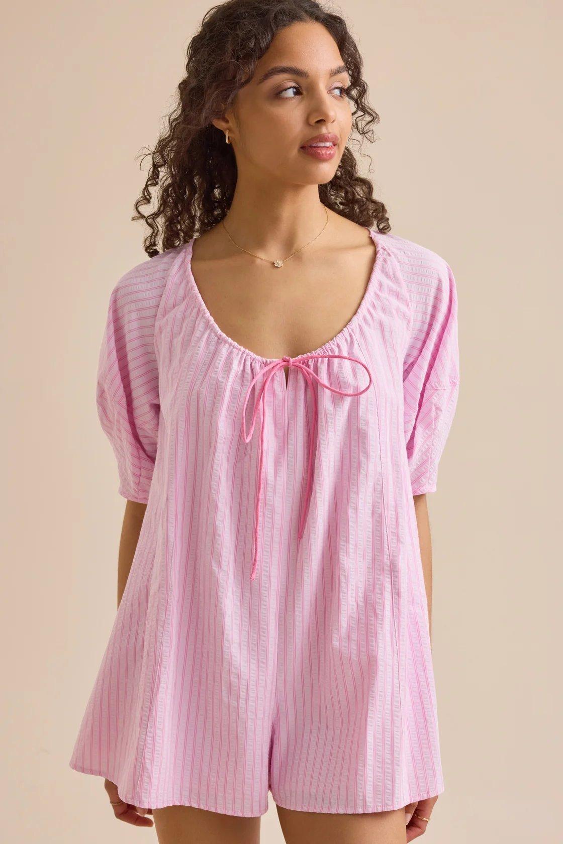 girl wearing a pink romper