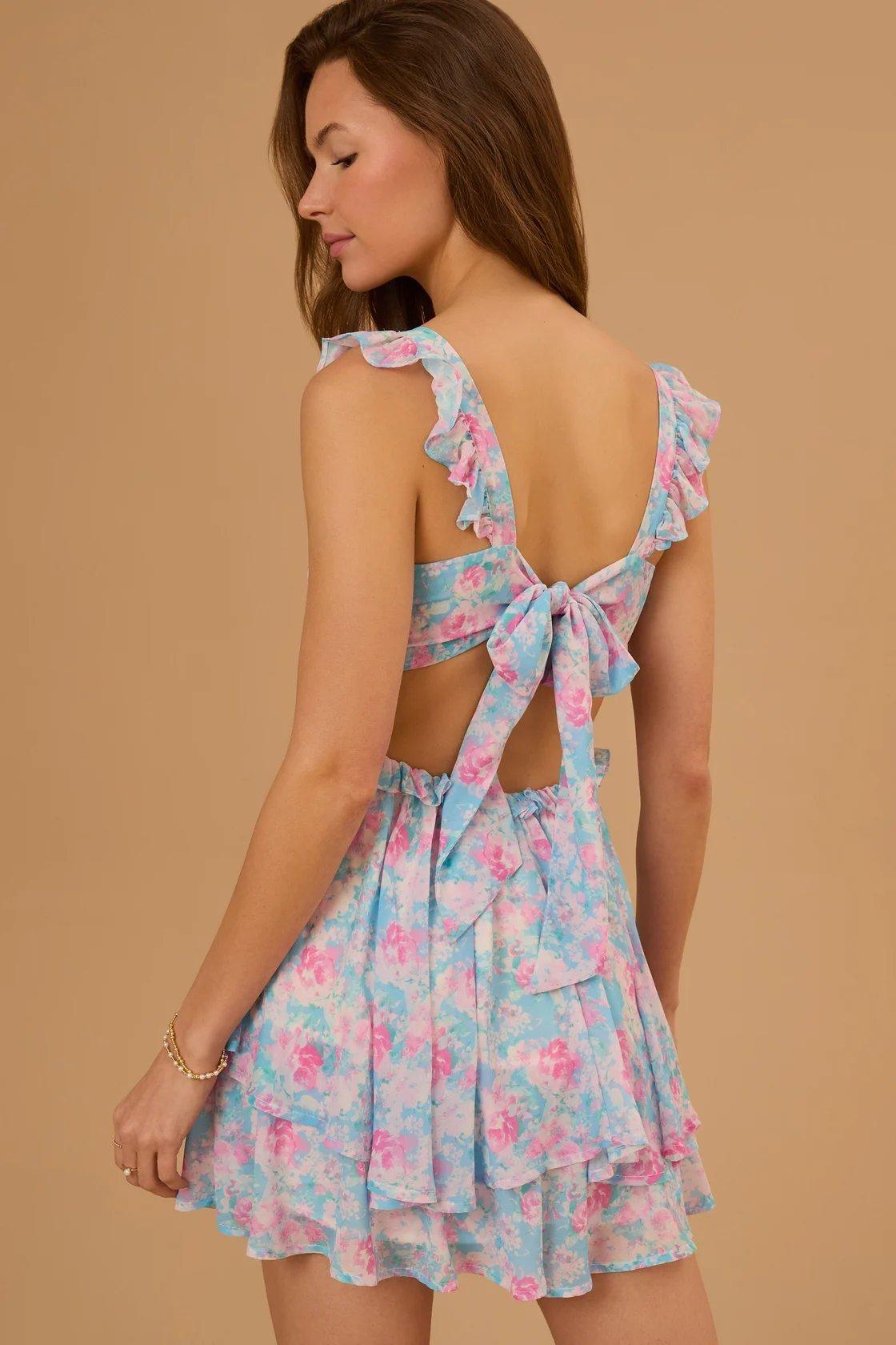 girl wearing a blue and pink floral romper