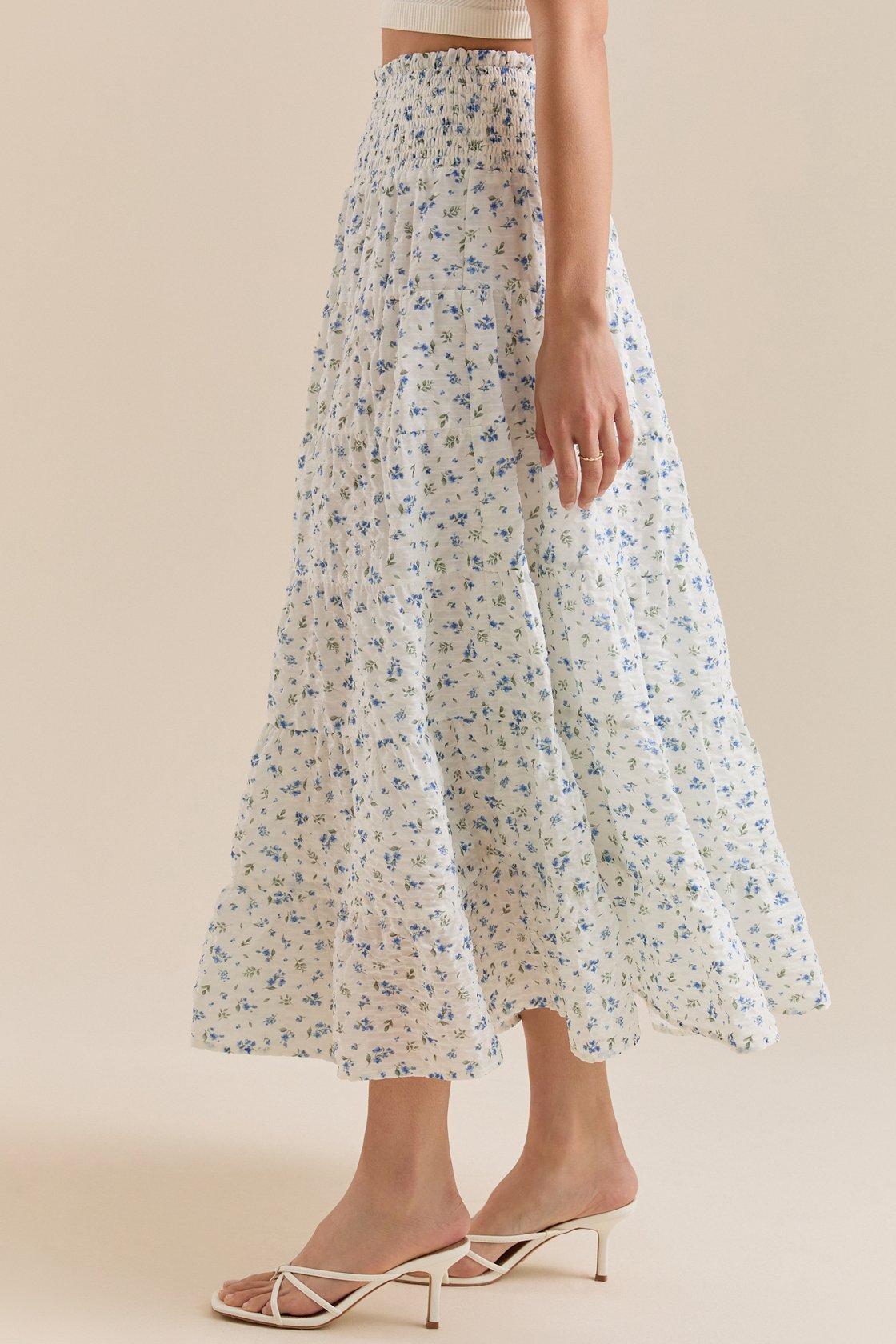 girl wearing an ivory and blue floral midi skirt