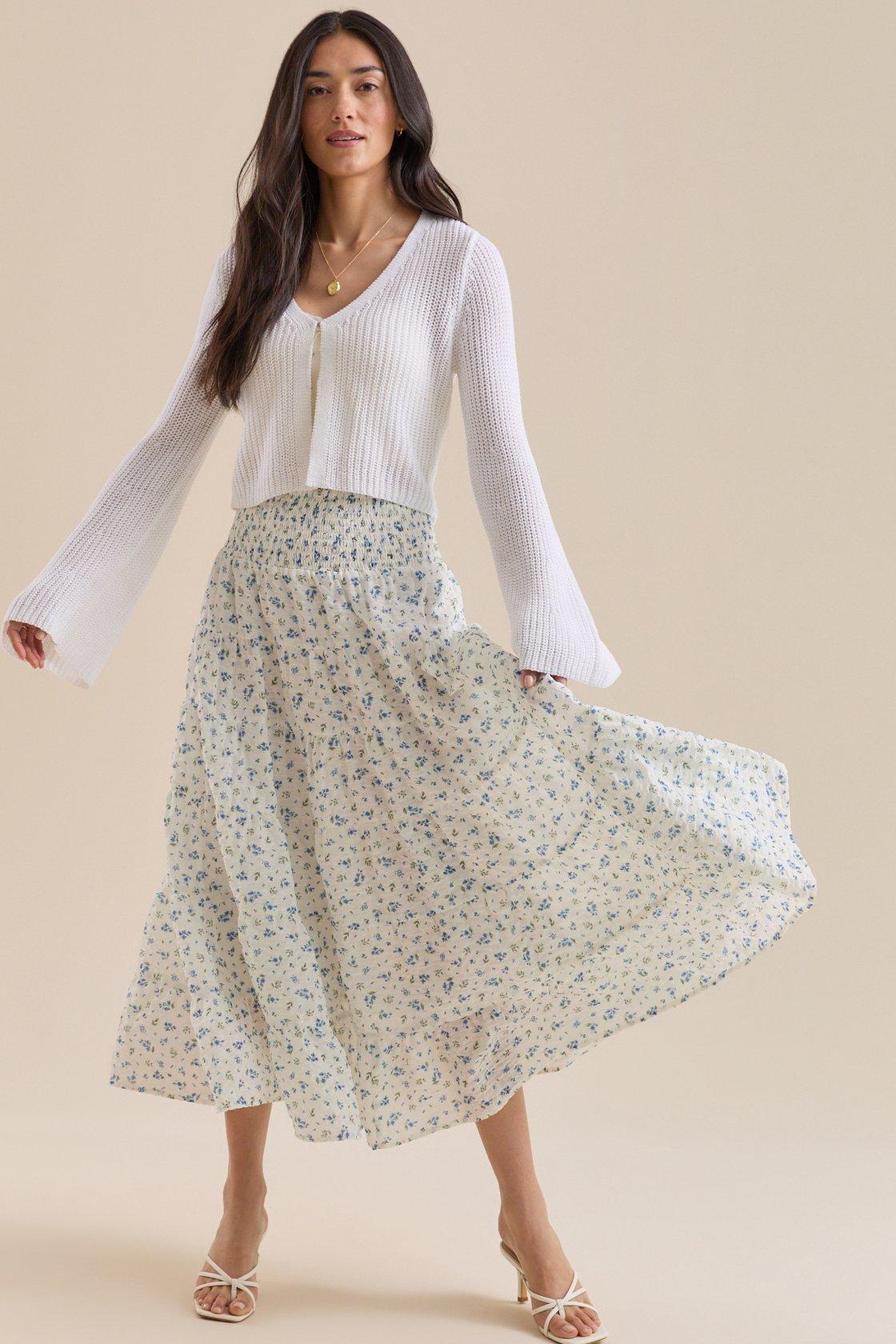 Girl wearing an ivory and blue floral midi skirt