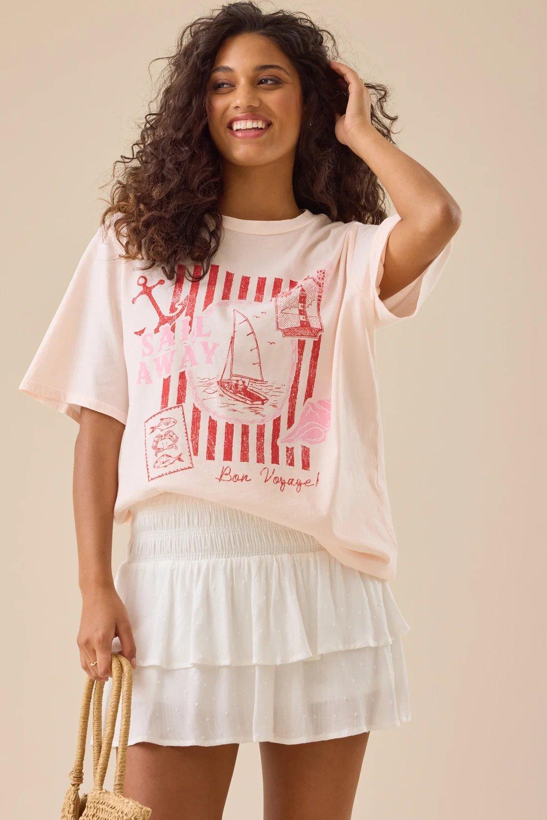 girl wearing light pink sail away graphic tee