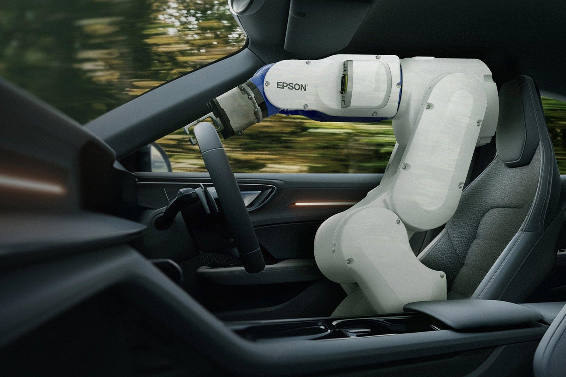 An Epson Robot in the drivers seat of a car