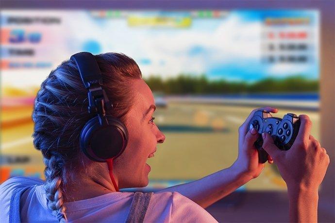 a man sitting on a couch playing a video game on a television