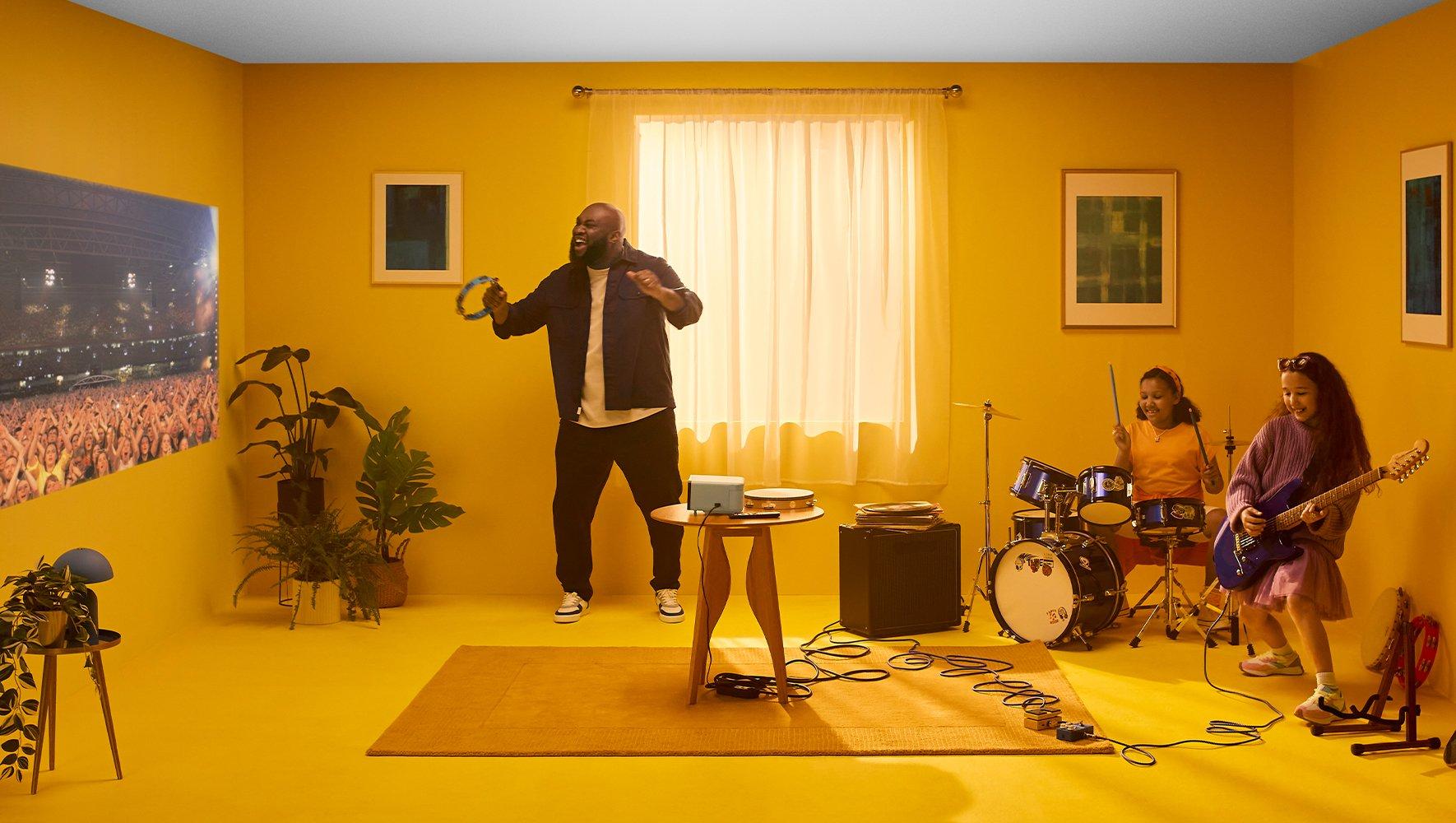 a group of people in a yellow room playing music