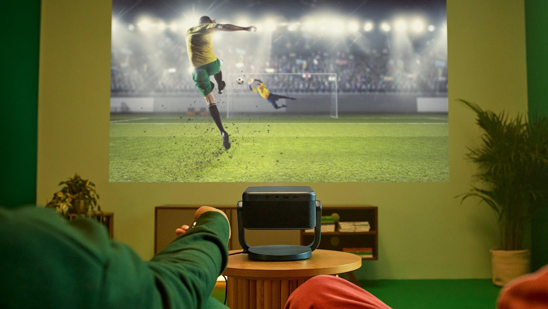 a man pointing at a camera with a sign that says world class products