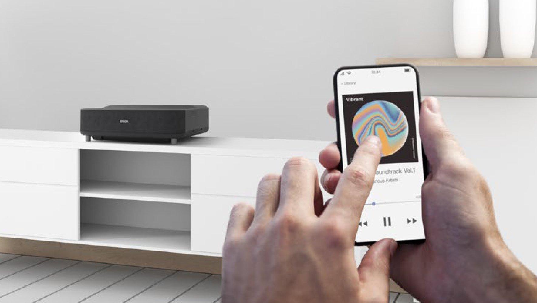 A projector and a smartphone connected via Bluetooth.