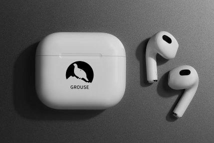 White wireless earbuds with a charging case featuring a black silhouette of a grouse.