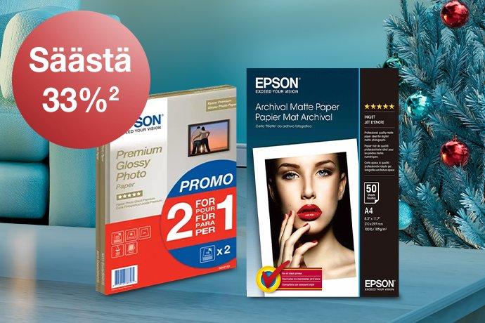 Epson Paper packs with a blue couc, red blanket and a Christmas tree in the background