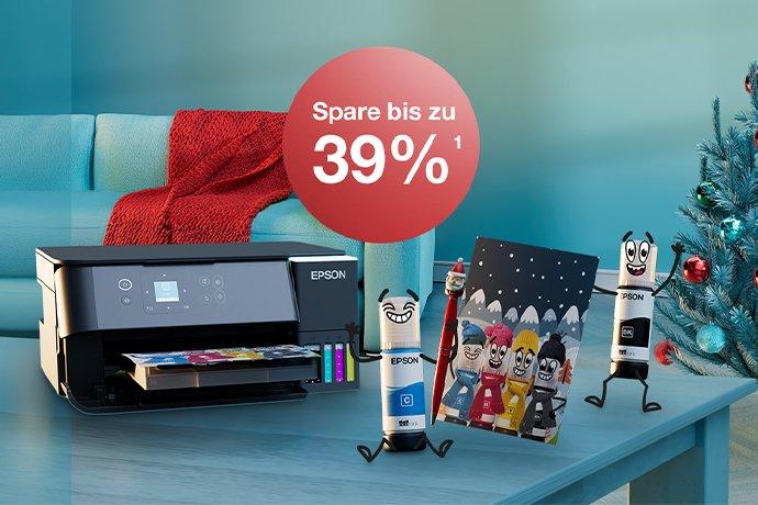 An Epson printer with Inkies and a Christmas card on a blue table with a Christmas tree in the back