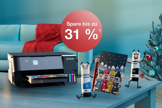 An Epson printer with Inkies and a Christmas card on a blue table with a Christmas tree in the back