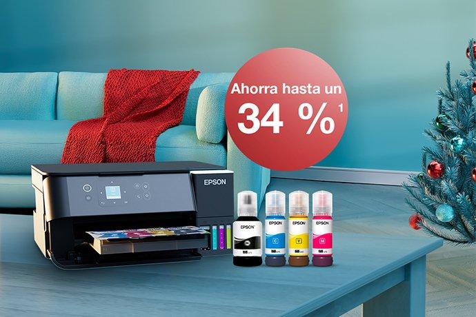 An Epson printer with ink bottles on a blue table with a Christmas tree in the back