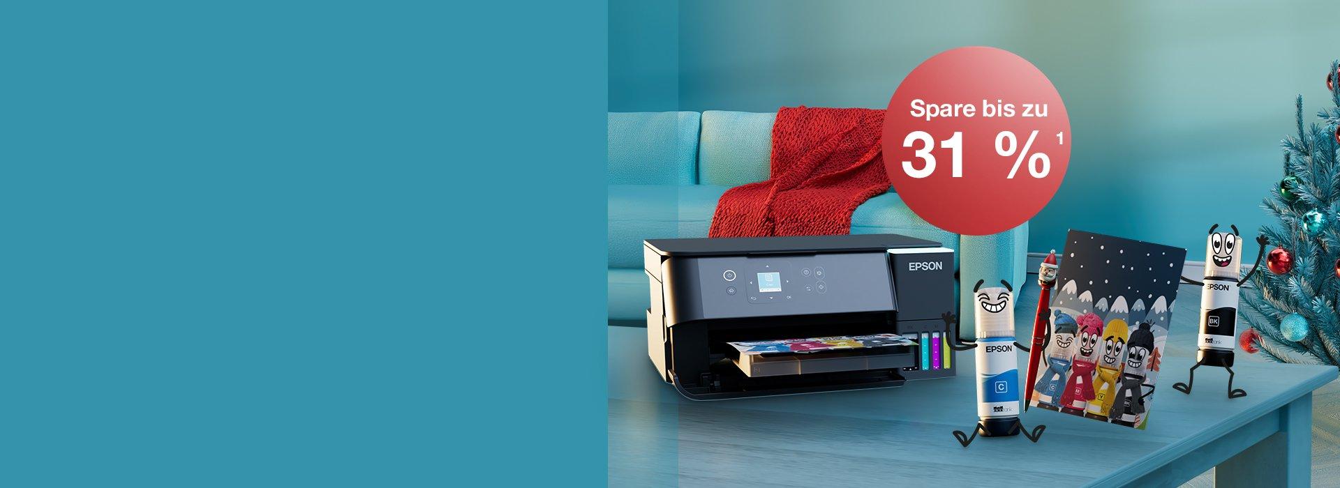 An Epson printer with Inkies and a Christmas card on a blue table with a Christmas tree in the back