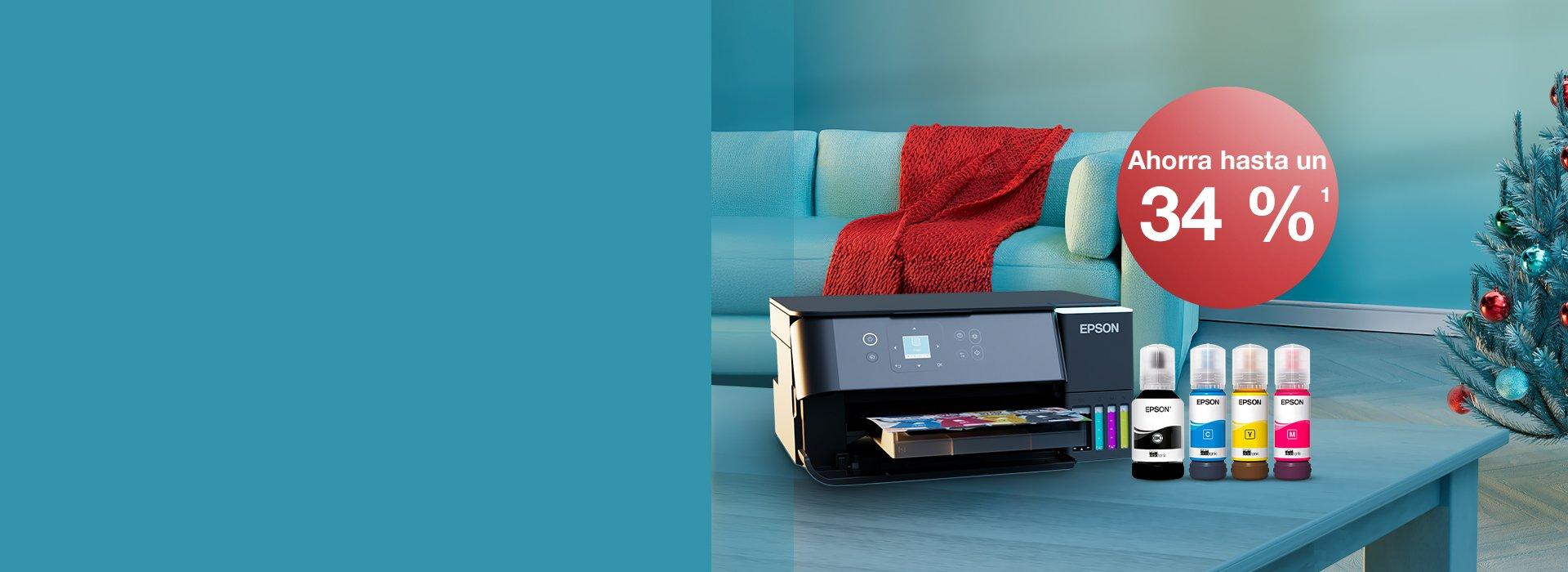 An Epson printer with Inkies and a Christmas card on a blue table with a Christmas tree in the back