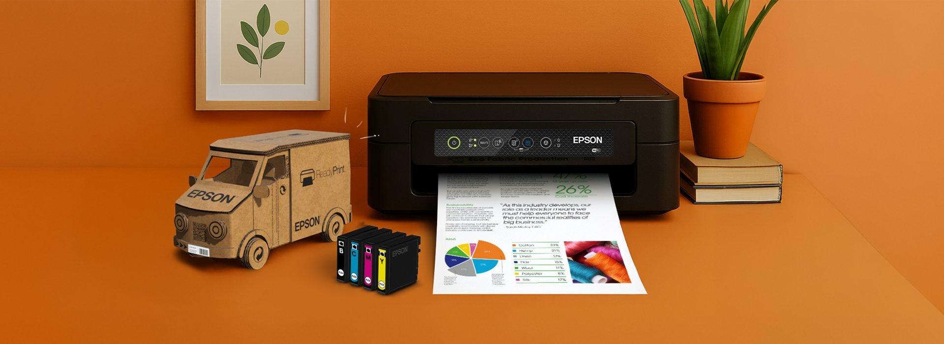 An Epson printer printing out a colourful document with images and a pie chart. Beside it is a small cardboard van with the Readyprint logo, and some ink cartridges.