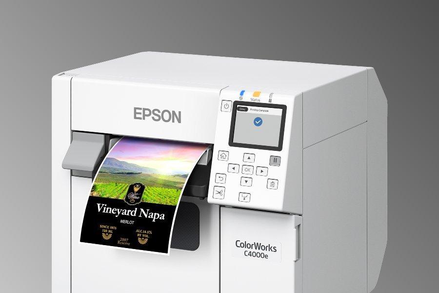 An Epson printer. printing of a colourful label with the text "Vineyard Napa - MERLOT" prominent.