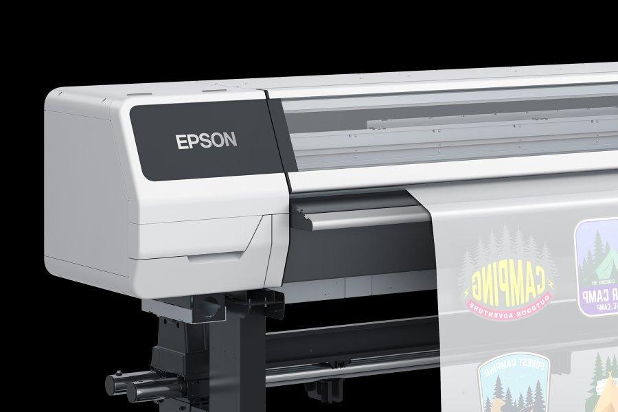 A close-up of the SureColor G9000 emphasising the Epson logo on the device, showing the printer printing off various design.