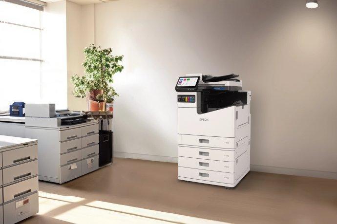 An Epson printer standing against the wall in an office.