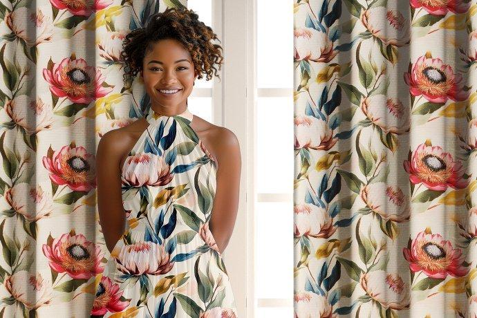A woman wearing a floral dress, standing in front of a window with floral curtains.