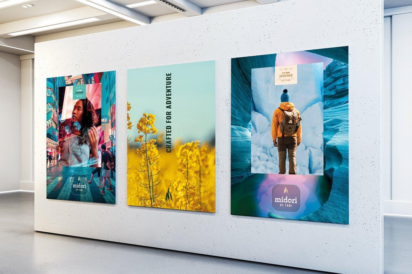 A gallery wall displays three vibrant posters. The first features a woman in a busy urban scene. 