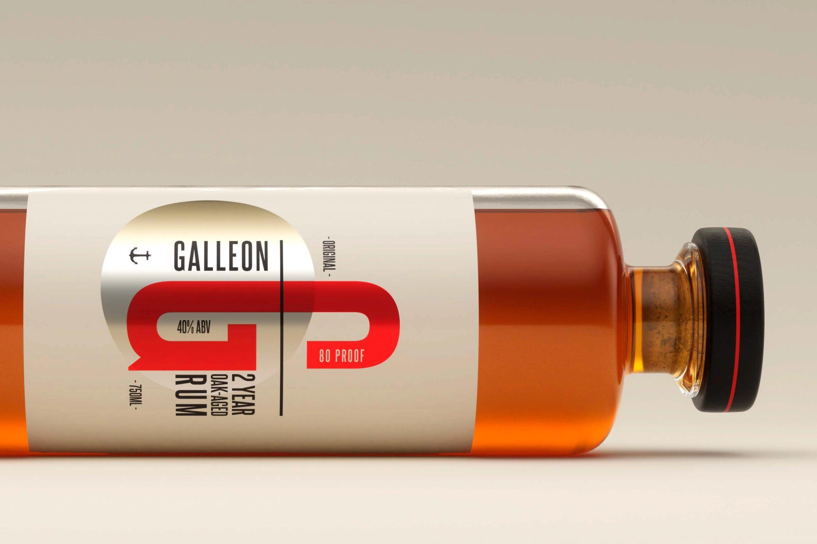 A horizontal bottle of Galleon 2-year oak-aged rum lies on its side.