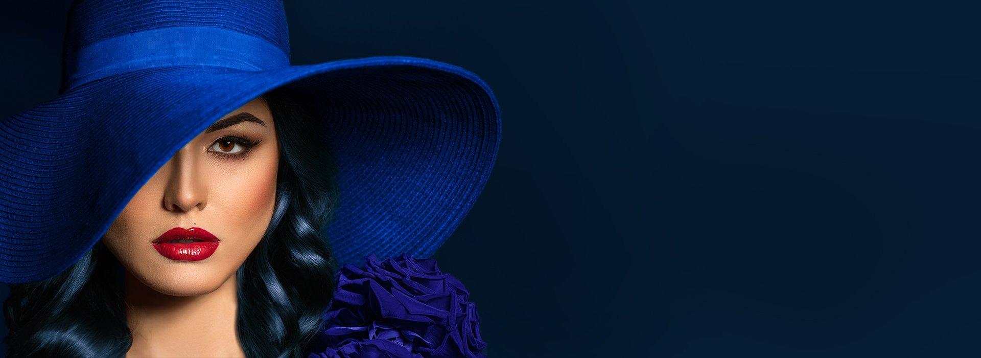 A print of a lady with black hair wearing a blue hat