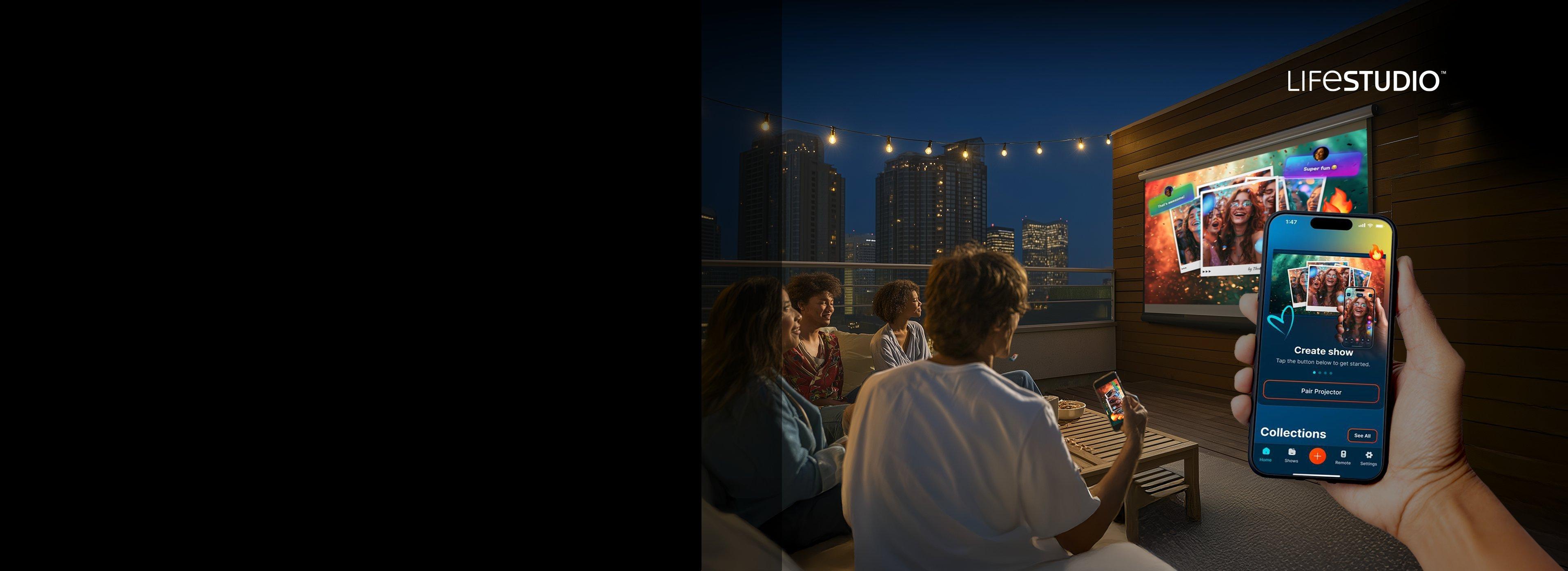 A group of people watch a projection against a wall at a rooftop seating area. Prominent in the foreground is a mobile phone with the Epson Projection Studip App open.