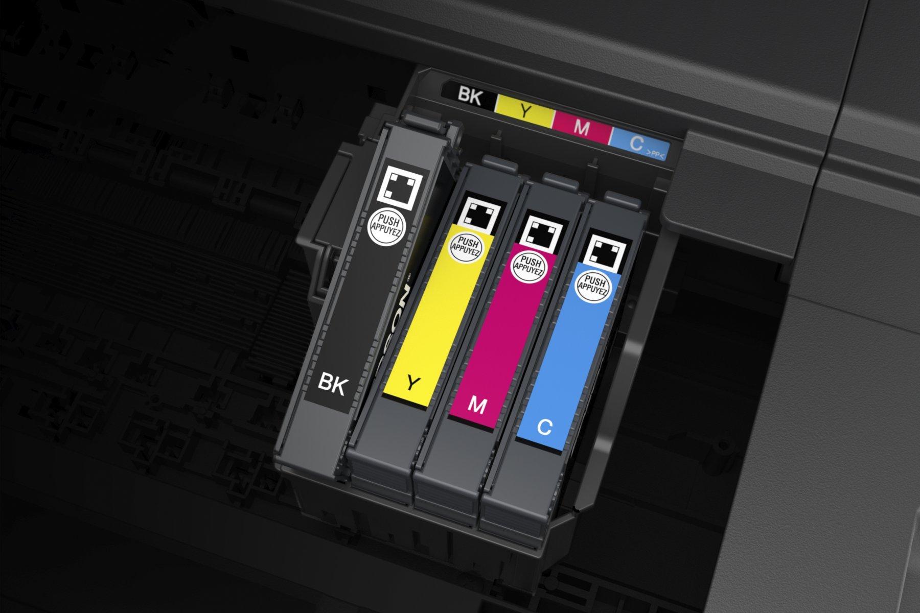 Four printer ink cartridges installed in a printer, labeled as black, yellow, magenta, and cyan, showcasing vivid colours and a sleek design.