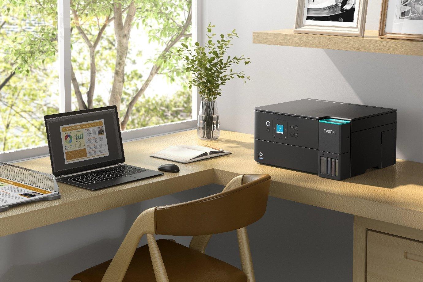 Printer and laptop on the desktop. 