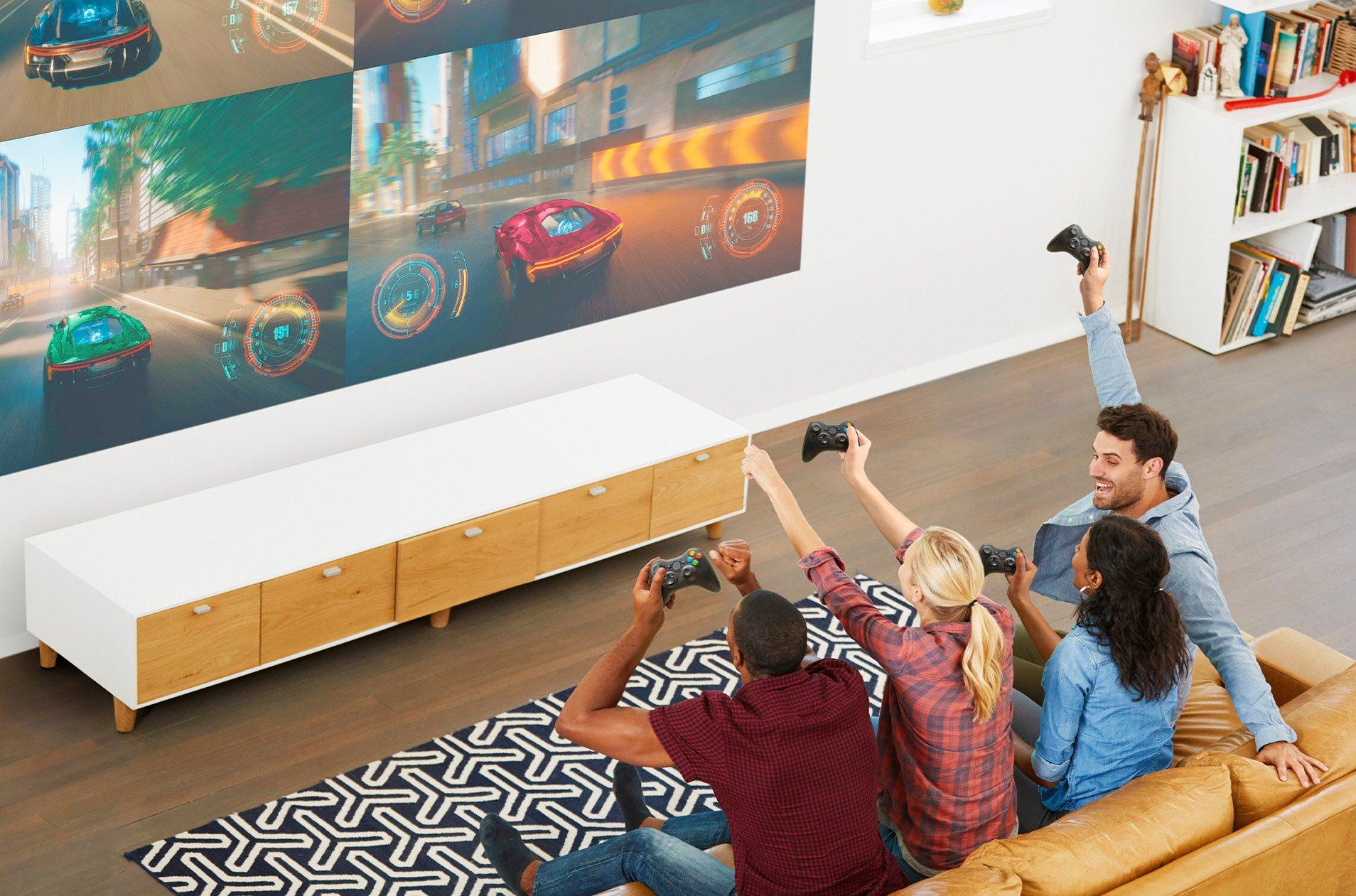 A group of friends playing a video game together on a big projector screen