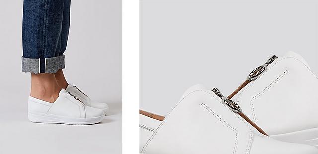 White Tennis style sneakers featuring zip detailing.