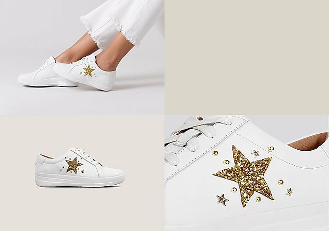 White leather Tennis style sneakers with gold embellished star print on the side and laces.