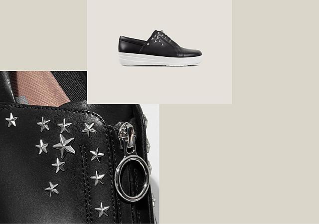 Black leather sneakers with silver star studs on the side and zip opening.