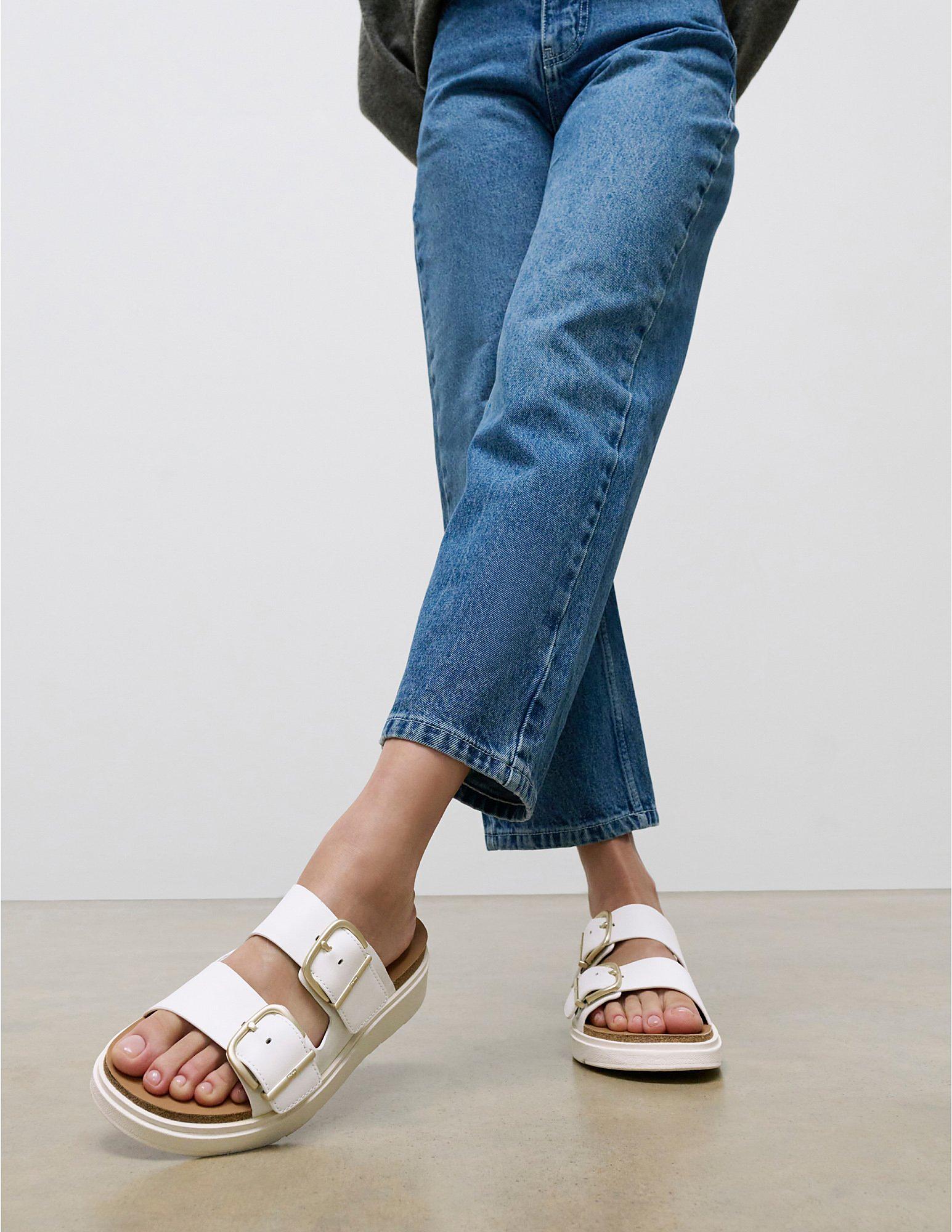 woman wearing the white Gen-FF two bar slides from the Fitflop collection